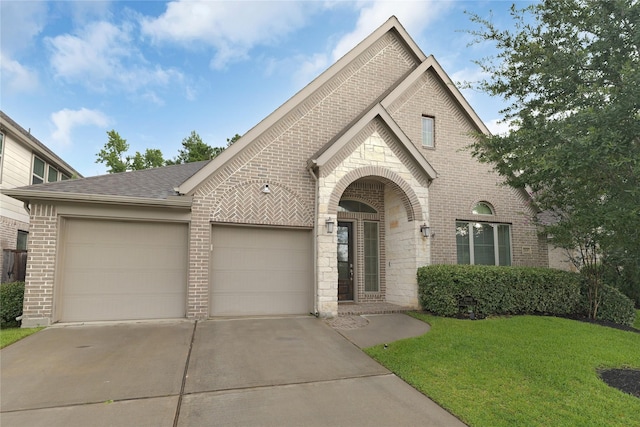 23649 Sage Villa Dr, New Caney, TX 77357 - view of front facade featuring brick siding, driveway, a garage, a front lawn, and roof with shingles