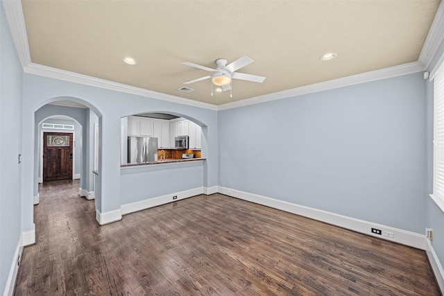 1773 Aden Dr, Houston, TX 77003 - unfurnished living room featuring a ceiling fan, arched walkways, dark wood finished floors, ornamental molding, and recessed lighting