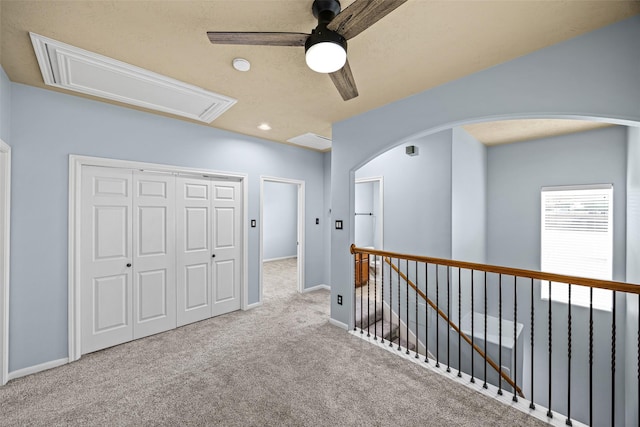1773 Aden Dr, Houston, TX 77003 - hall featuring attic access, carpet flooring, an upstairs landing, arched walkways, and recessed lighting