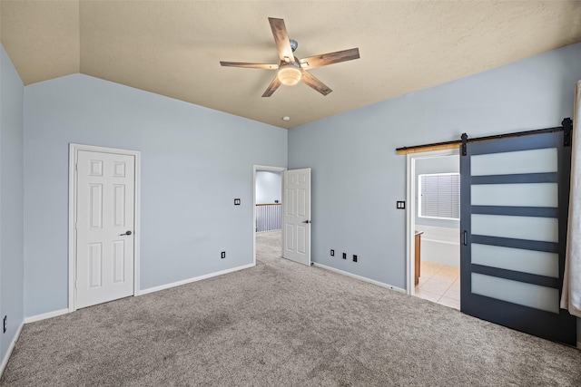 1773 Aden Dr, Houston, TX 77003 - unfurnished bedroom with carpet flooring, a barn door, lofted ceiling, ceiling fan, and ensuite bath