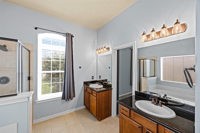 1773 Aden Dr, Houston, TX 77003 - bathroom featuring a shower stall, two vanities, tile patterned floors, and a garden tub