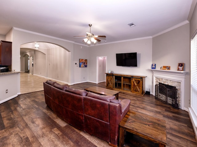 6111 Windsor Chase Ln, League City, TX 77573 - living area with ceiling fan, wood finished floors, arched walkways, ornamental molding, and a stone fireplace