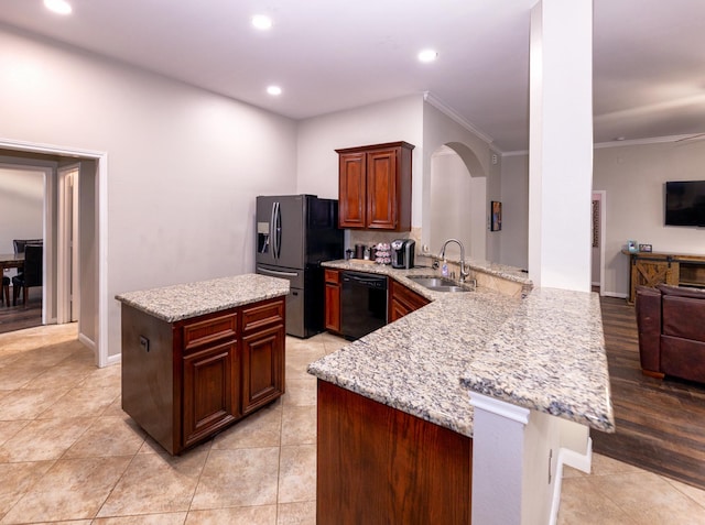 6111 Windsor Chase Ln, League City, TX 77573 - kitchen with black appliances, a peninsula, light stone counters, recessed lighting, and arched walkways