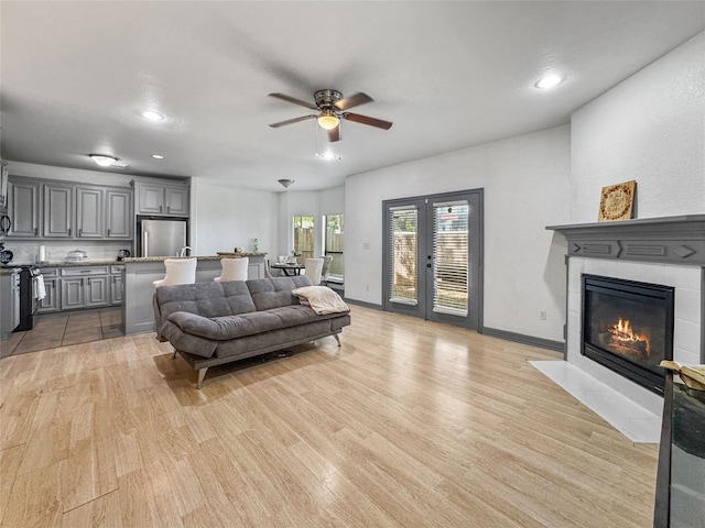 2905 Baer St Unit 6, Houston, TX 77020 - living area with a ceiling fan, light wood-style flooring, a tile fireplace, and recessed lighting