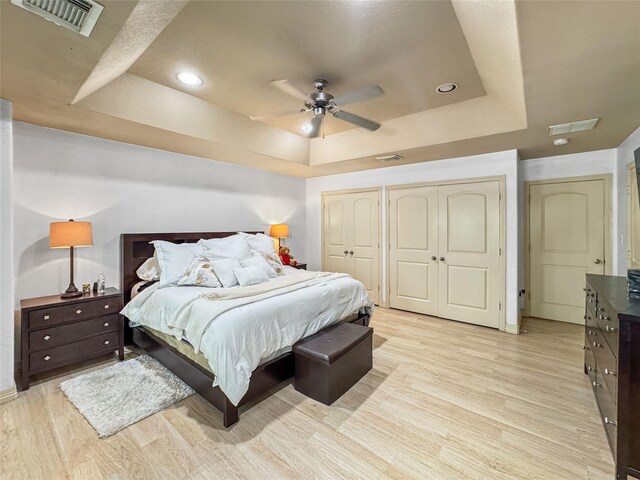 2905 Baer St Unit 6, Houston, TX 77020 - bedroom with a tray ceiling, light wood finished floors, and ceiling fan