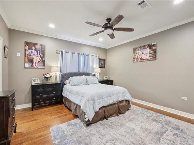 2700 Spurlock Rd, Nederland, TX 77627 - bedroom with crown molding, light wood-style floors, recessed lighting, and ceiling fan
