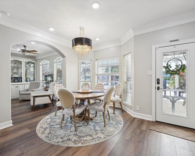 2700 Spurlock Rd, Nederland, TX 77627 - dining space with a chandelier, healthy amount of natural light, wood finished floors, ornamental molding, and arched walkways