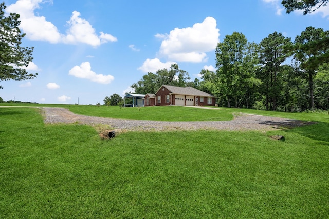 4920 Fm 350 N, Livingston, TX 77351 - view of green lawn featuring driveway and an attached garage