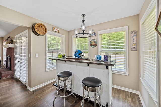 4920 Fm 350 N, Livingston, TX 77351 - kitchen with dark wood-style flooring, healthy amount of natural light, a kitchen breakfast bar, and a chandelier