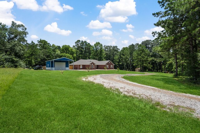 4920 Fm 350 N, Livingston, TX 77351 - view of grassy yard with gravel driveway and a detached garage