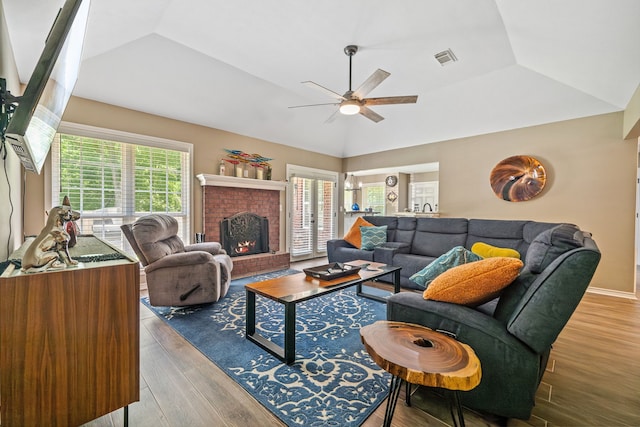 4920 Fm 350 N, Livingston, TX 77351 - living room with a ceiling fan, vaulted ceiling, wood finished floors, and a brick fireplace