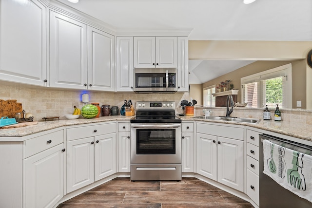 4920 Fm 350 N, Livingston, TX 77351 - kitchen with appliances with stainless steel finishes, white cabinets, decorative backsplash, and dark wood finished floors