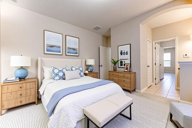 5002 Sawmill Terrace Ln, Spring, TX 77389 - bedroom featuring arched walkways and light tile patterned floors
