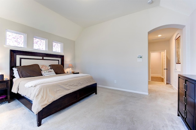 5002 Sawmill Terrace Ln, Spring, TX 77389 - bedroom featuring arched walkways, vaulted ceiling, and light carpet