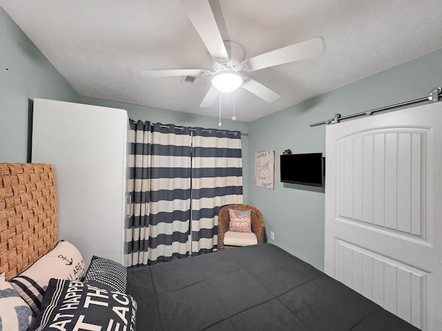 1031 Rollover 2, Gilchrist, TX 77617 - bedroom featuring a barn door and ceiling fan