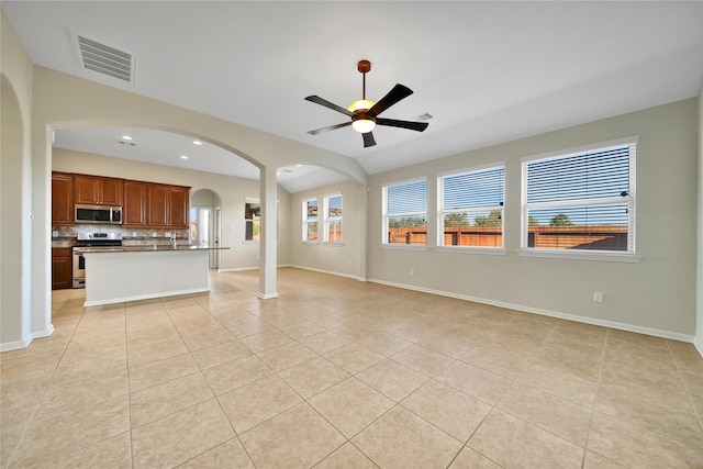 208 Harbor Bend Ln, Dickinson, TX 77539 - unfurnished living room featuring light tile patterned flooring, a ceiling fan, arched walkways, and recessed lighting