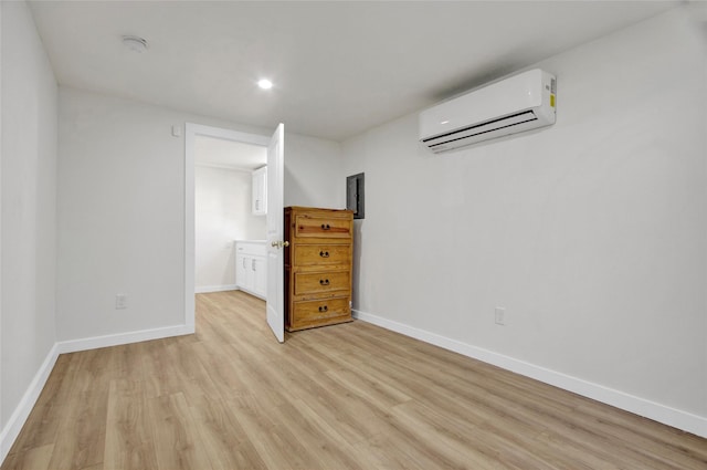 4716 Siegel St, Houston, TX 77009 - unfurnished bedroom featuring a wall mounted AC, light wood-style flooring, and recessed lighting