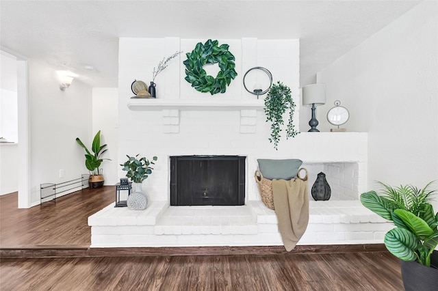 5518 Fair Forest Dr, Houston, TX 77088 - living area with a brick fireplace, a baseboard radiator, and wood finished floors