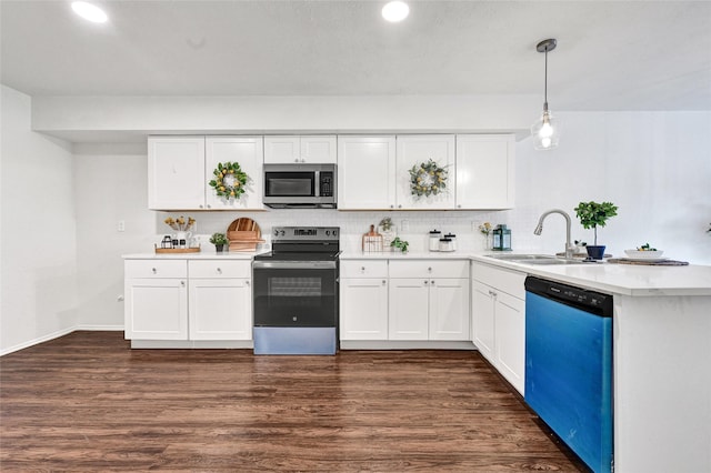 5518 Fair Forest Dr, Houston, TX 77088 - kitchen with appliances with stainless steel finishes, a peninsula, light countertops, dark wood-type flooring, and backsplash