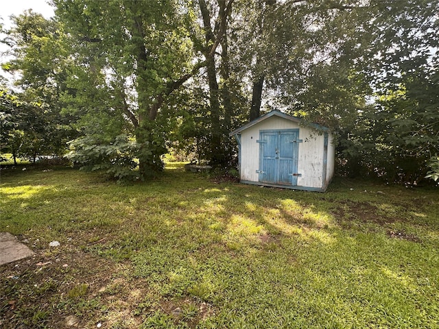 7706 Claiborne St, Houston, TX 77016 - view of grassy yard with a storage shed