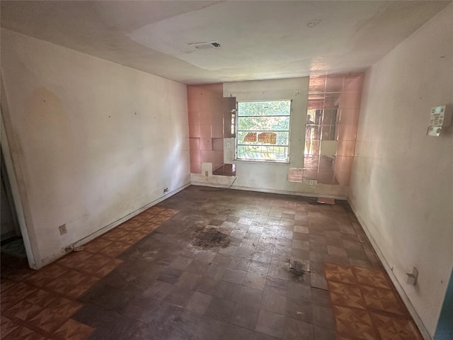 7706 Claiborne St, Houston, TX 77016 - spare room with baseboards and dark flooring