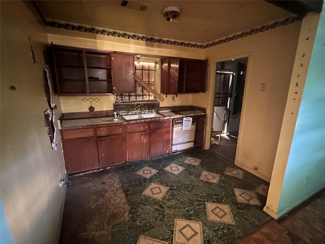 7706 Claiborne St, Houston, TX 77016 - kitchen with white dishwasher and open shelves