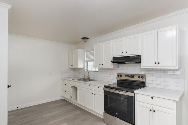 113 N Holmes St, La Porte, TX 77571 - kitchen with stainless steel range with electric cooktop, under cabinet range hood, tasteful backsplash, light wood-style floors, and white cabinetry
