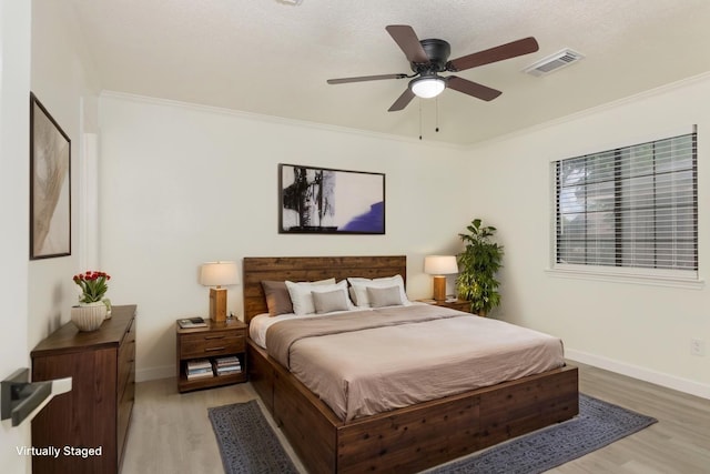 113 N Holmes St, La Porte, TX 77571 - bedroom featuring light wood finished floors, crown molding, and ceiling fan