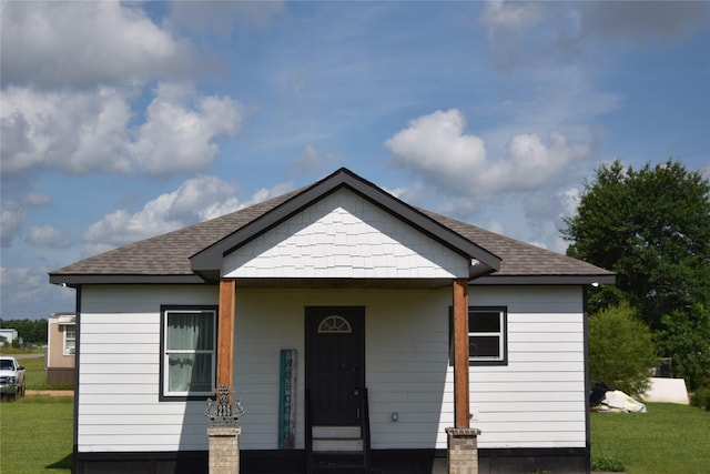 235 Rd 5253, Cleveland, TX 77327 - bungalow-style home with a front lawn and roof with shingles
