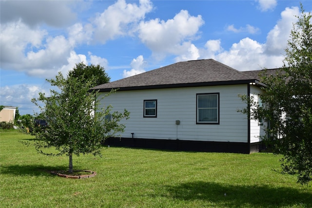 235 Rd 5253, Cleveland, TX 77327 - view of home's exterior featuring a yard and roof with shingles