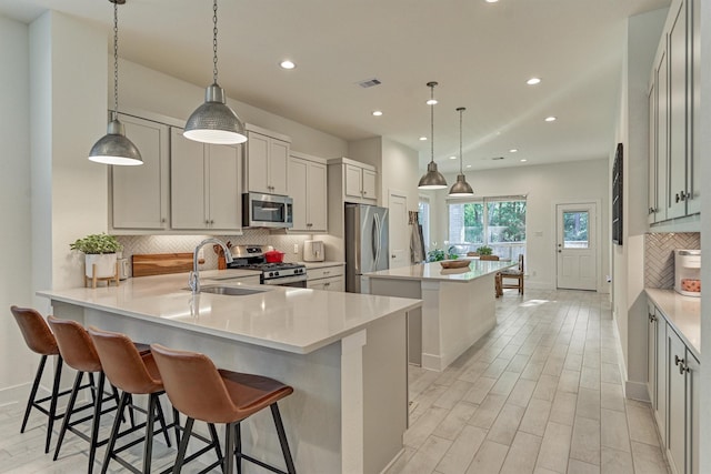 454 Glacier Pass, Montgomery, TX 77316 - kitchen featuring appliances with stainless steel finishes, a kitchen island, tasteful backsplash, recessed lighting, and light countertops
