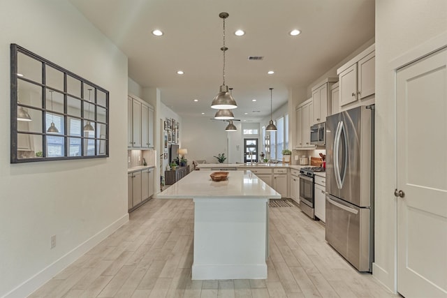 454 Glacier Pass, Montgomery, TX 77316 - kitchen with stainless steel appliances, recessed lighting, light wood-type flooring, a center island, and light countertops