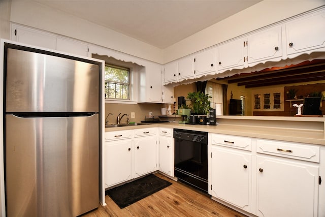 2019 N Thompson St, Conroe, TX 77301 - kitchen with freestanding refrigerator, dishwasher, light wood finished floors, and white cabinets