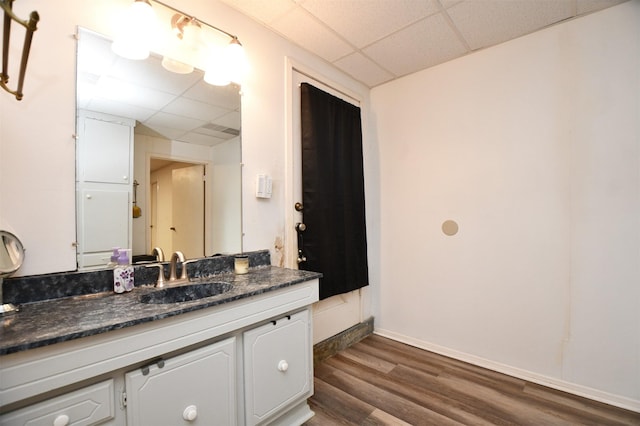 2019 N Thompson St, Conroe, TX 77301 - bathroom featuring a paneled ceiling, wood finished floors, and vanity