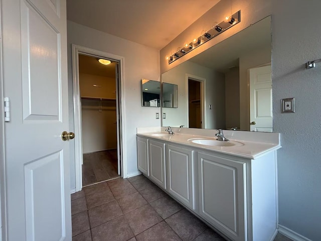 16623 Newglen Ln, Houston, TX 77084 - bathroom featuring double vanity, tile patterned floors, and a spacious closet