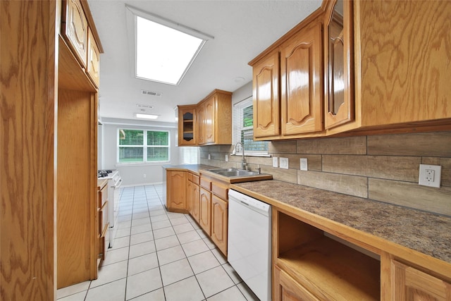 24193 Kelly St, Porter, TX 77365 - kitchen with white appliances, light tile patterned floors, tasteful backsplash, and brown cabinets
