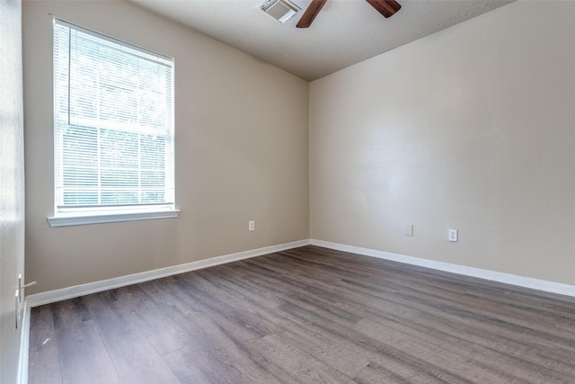 8130 Jutland Rd, Houston, TX 77033 - spare room featuring healthy amount of natural light, wood finished floors, and a ceiling fan