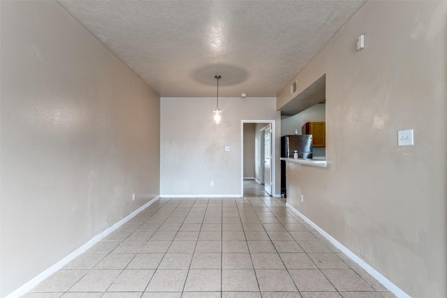 8130 Jutland Rd, Houston, TX 77033 - unfurnished room featuring a textured ceiling and light tile patterned floors