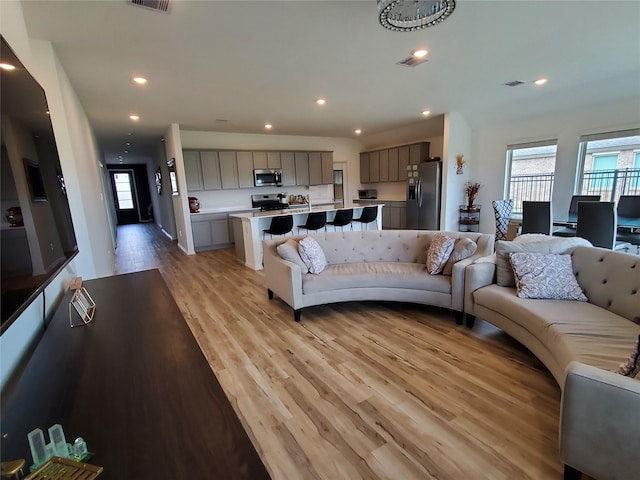 2944 Cordova Hill Dr, Katy, TX 77493 - living room featuring healthy amount of natural light, light wood-style floors, and recessed lighting