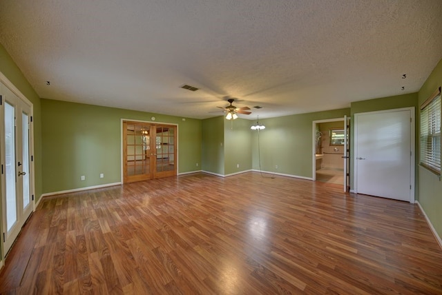 5425 Sandy Creek Ln, Brenham, TX 77833 - empty room with french doors, a textured ceiling, wood finished floors, and a ceiling fan
