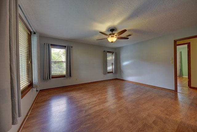 5425 Sandy Creek Ln, Brenham, TX 77833 - spare room featuring ceiling fan, wood finished floors, and a textured ceiling