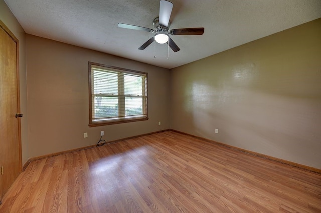 5425 Sandy Creek Ln, Brenham, TX 77833 - empty room with light wood-type flooring, ceiling fan, and a textured ceiling