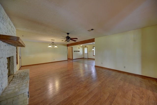 5425 Sandy Creek Ln, Brenham, TX 77833 - unfurnished living room featuring a large fireplace, a ceiling fan, and wood finished floors