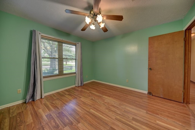 5425 Sandy Creek Ln, Brenham, TX 77833 - unfurnished bedroom featuring wood finished floors, a ceiling fan, and a textured ceiling