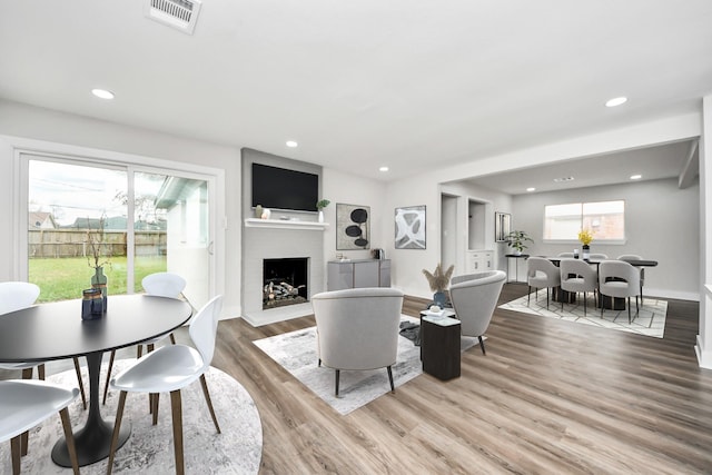 9414 Colleen Rd, Houston, TX 77080 - living area with light wood finished floors, a fireplace with raised hearth, and recessed lighting