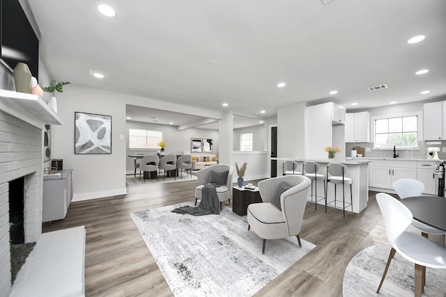 9414 Colleen Rd, Houston, TX 77080 - living area featuring recessed lighting, a fireplace, and light wood-style floors
