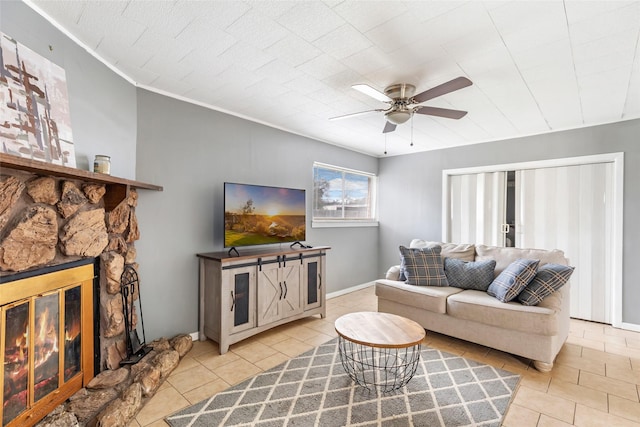 7730 Wickersham Pl, Beaumont, TX 77706 - living room featuring tile patterned flooring, a ceiling fan, and a fireplace