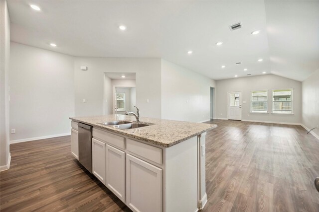 2539 Blazing Star Dr, Brookshire, TX 77423 - kitchen with dishwasher, wood finished floors, vaulted ceiling, an island with sink, and light stone countertops