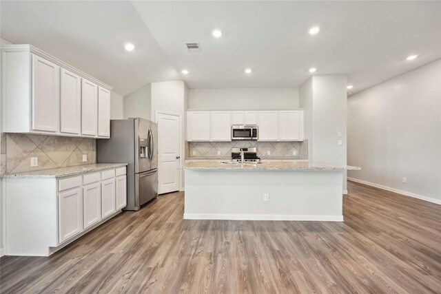2539 Blazing Star Dr, Brookshire, TX 77423 - kitchen with appliances with stainless steel finishes, tasteful backsplash, white cabinetry, and recessed lighting