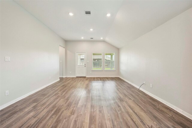 2539 Blazing Star Dr, Brookshire, TX 77423 - unfurnished living room featuring wood finished floors, recessed lighting, and vaulted ceiling